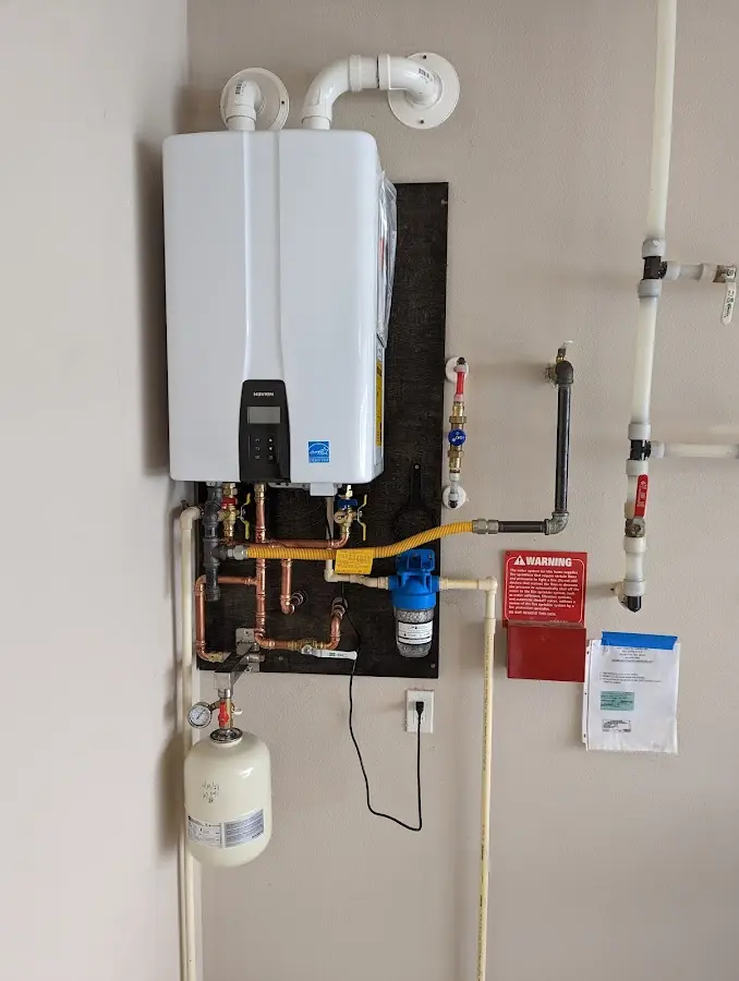 Professional plumber installing copper piping in a North Terre Haute home